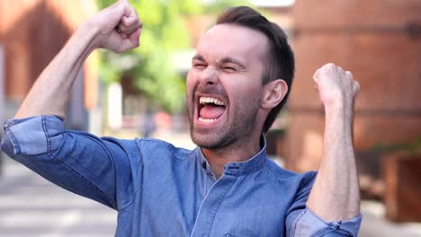 casual man celebrating success  gesture in offcie