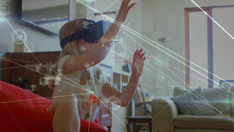 niña agitando las manos mientras usa un auricular de realidad virtual