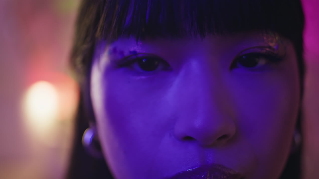 Chinese girl posing nightclub closeup. woman eyes with shiny makeup