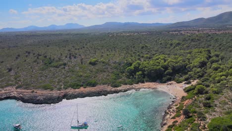 cala varques offers breathtaking views of turquoise waters and a rugged coastline in majorca. enjoy the serene beauty and tranquil atmosphere as boats glide through the bay.