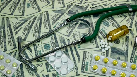 slider shot of dollar bills and medicine on the table