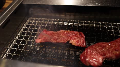 스테이크가 그릴에서 서서히 조리되고 있습니다.
