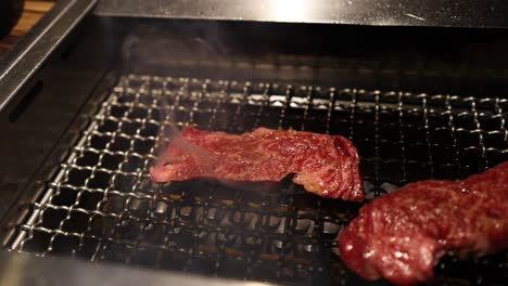 steak cooking gradually on a grill