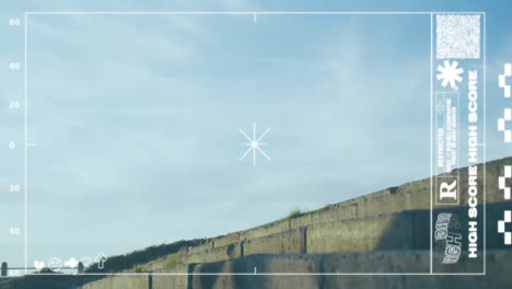 Targeting reticle and high score animation over stone steps and blue sky