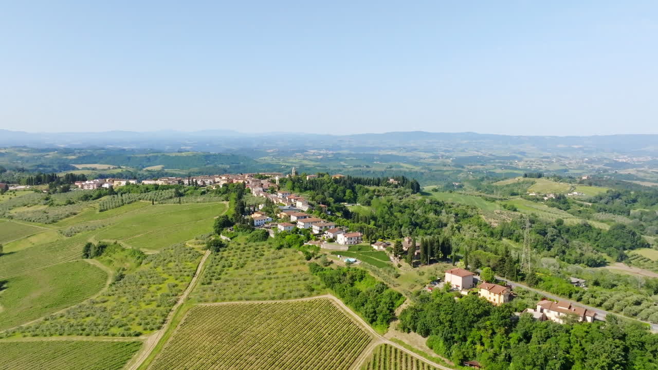 Aerial view toward a idyllic Tuscan village, sunny, summer day in Tuscany, Italy