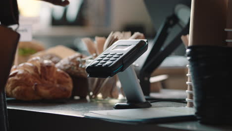 close up customer using smart watch making contactless payment mobile money transfer in cafe enjoying service in restaurant cafe