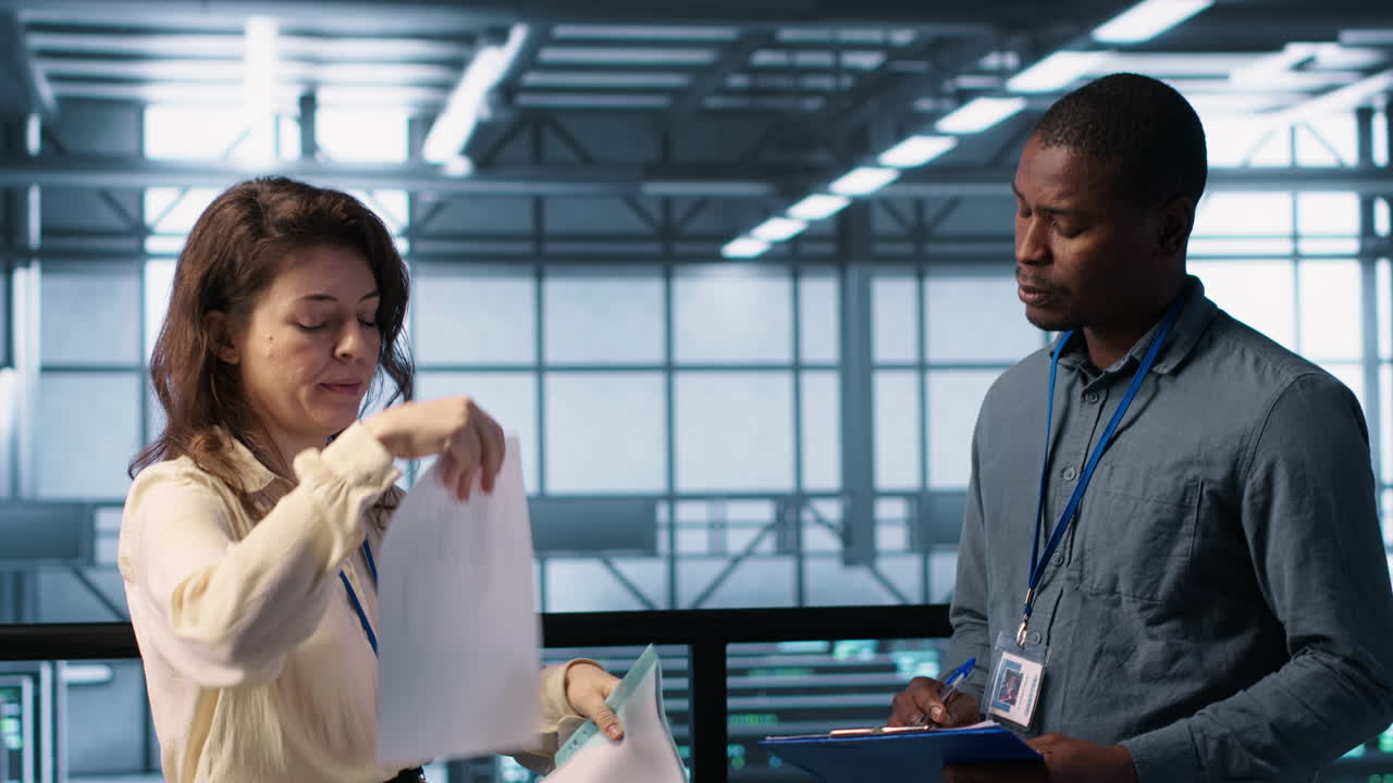 Server room admins looking over financial documents