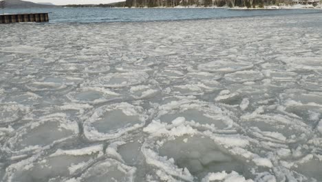 Frozen-lake-shoreline-aerial-4K