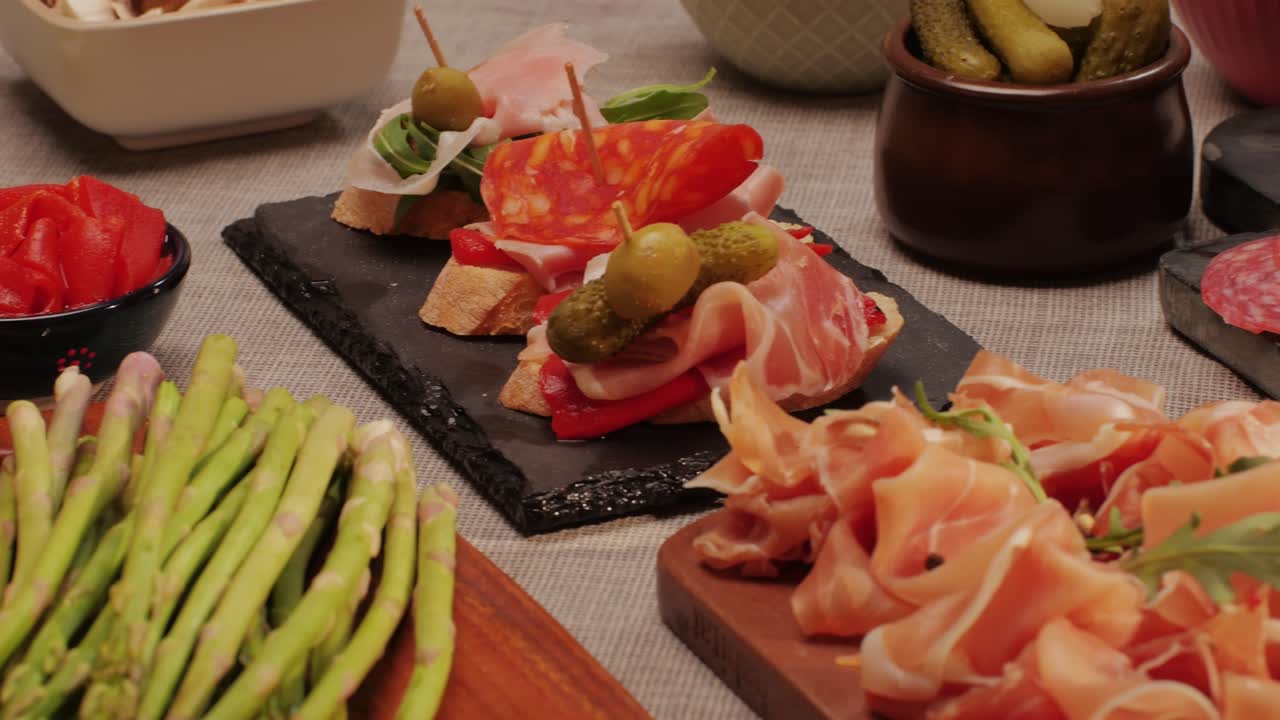 Italian or Spanish restaurant with traditional tapas food, Spanish cuisine, delicious tapas and cheese plate, bruschetta with cheese, olives dry tomatoes and tasty sandwich bar appetizer, buffet