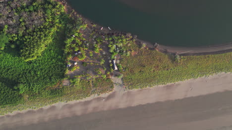 Aerial-spiral-shot-of-a-small-building-on-the-view-of-Canas-Island