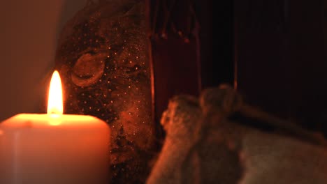 relaxing background close up shot of some herbs in small bags, with a candle with a flickering flame and old books