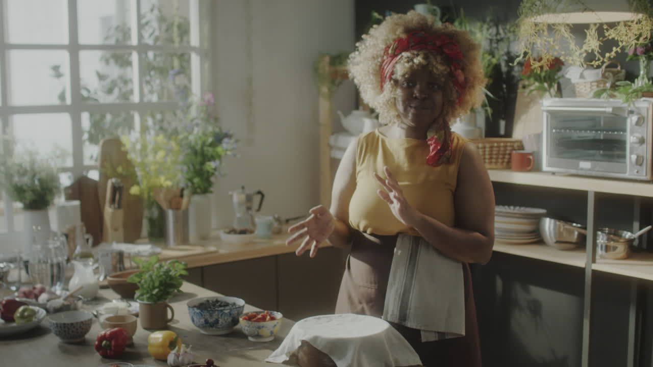 Woman Preparing and Explaining a Recipe in a Rustic Kitchen