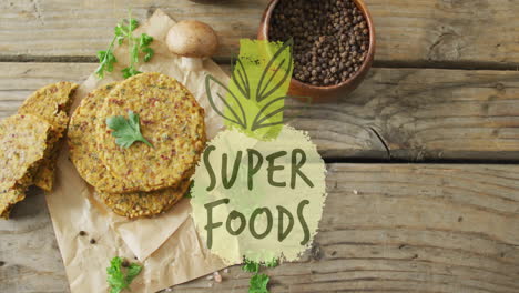 super foods text animation over healthy food ingredients on rustic wooden table