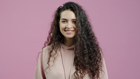 woman with curly hair pointing