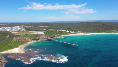 catherine hill bay pier on nsw australia coastline, aerial reveal over bay