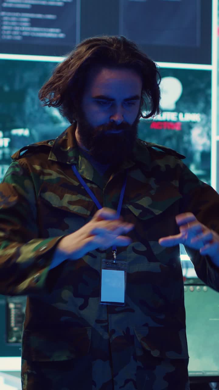 Bearded Man in Camouflage Jacket Interacting with High-Tech Screens