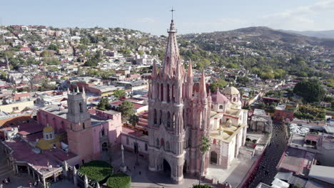 aerial drone shot of san miguel de allende town, the church of san miguel arcangel, and jardín allende. guanajuato, mexico. 4k