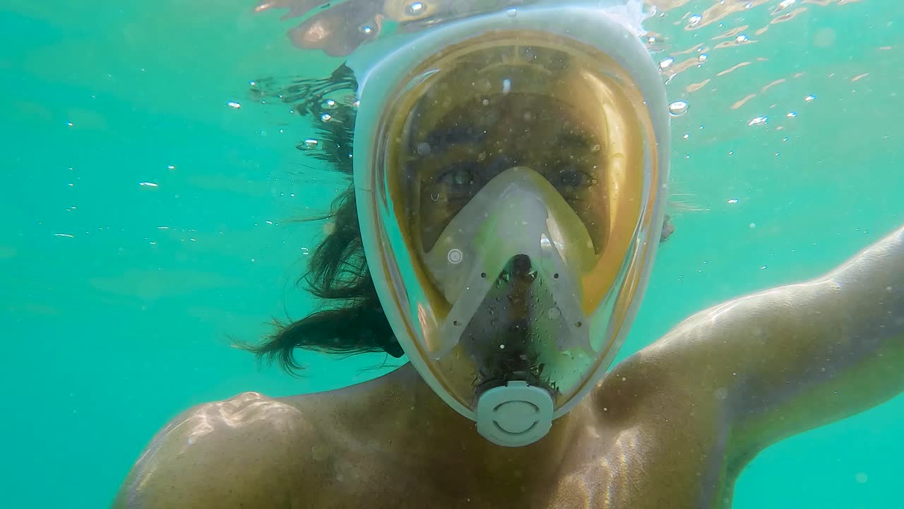 Man snorkeling with a full-face mask in the clear waters of Palavas, France. Capturing underwater adventure, marine exploration, and summer holiday vibes