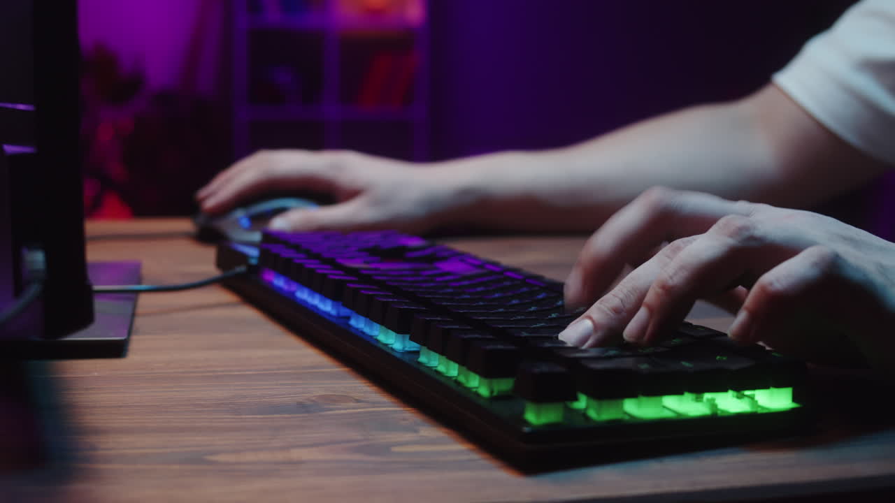 Close-up of Gamer's Hands Using RGB Keyboard and Mouse