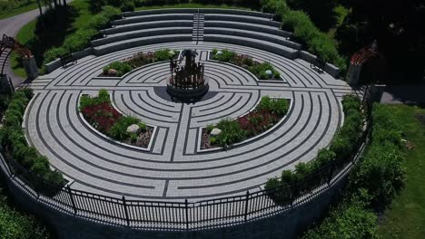 pull out aerial drone over cullen central park gardens with monument of remembrance in whitby, canada