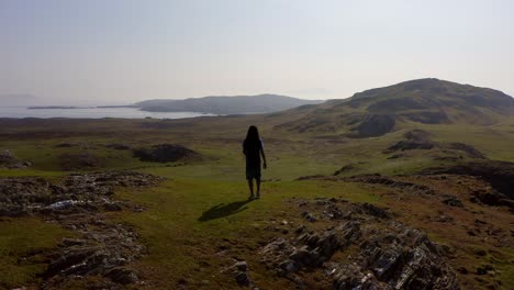 Man-with-dreads-walks-an-empty-field-of-a-beautiful-island