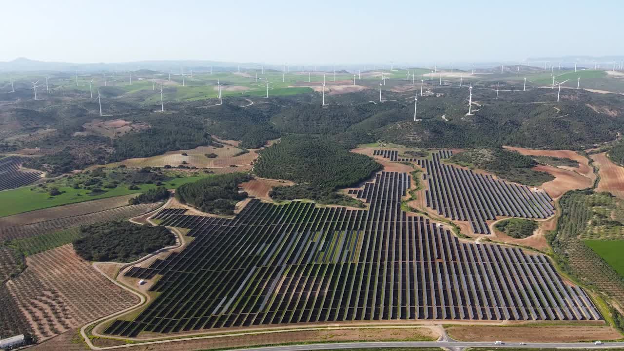 Aerial View of Solar and Wind Farms in Rural Landscape