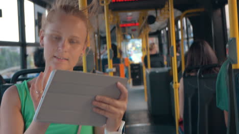 smiling woman with tablet in bus