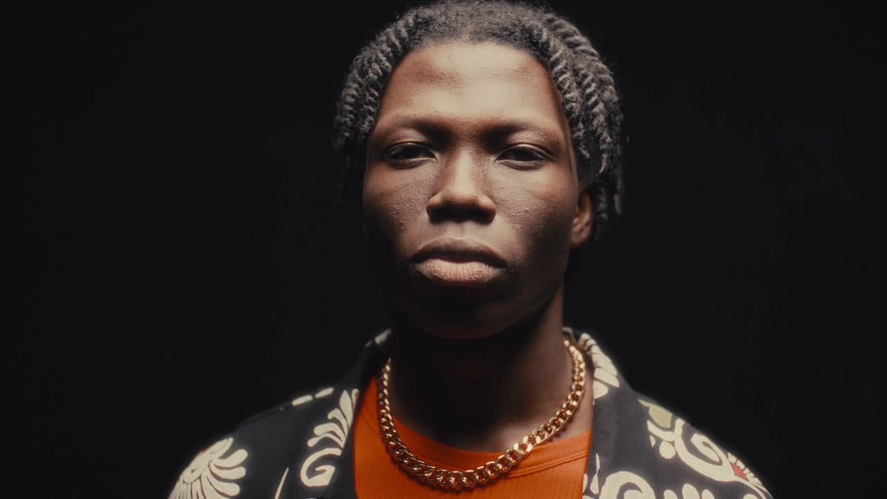 Portrait of Handsome Black Man against Dark Studio Background