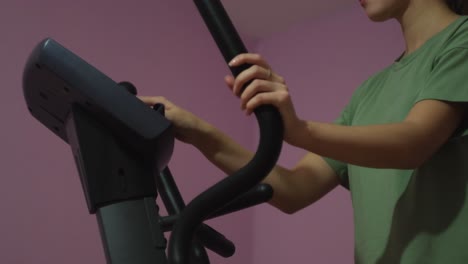 teenage girl exercising on a cross-trainer