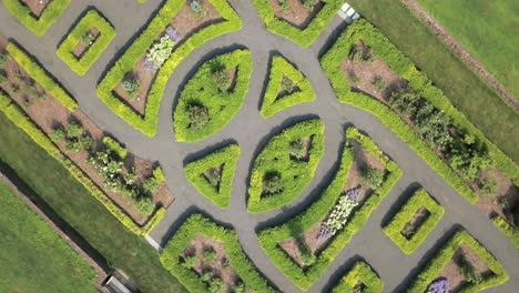 top down rotating view of symmetrical green park and paths