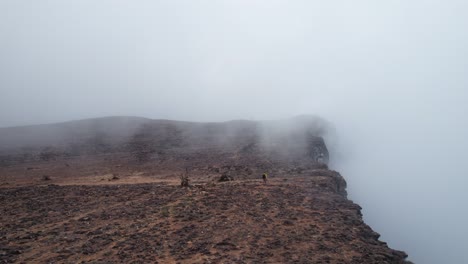 Man-hiking-on-a-mountain-in-clouds