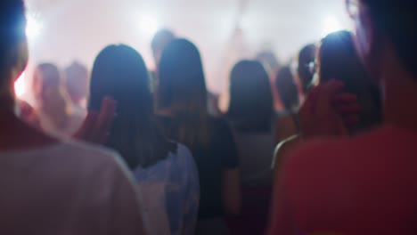 concert audience is clapping hands and applauding on music live show event