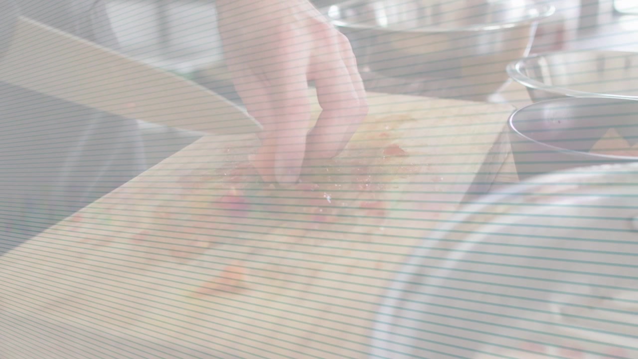 Right hand gripping kitchen knife, cook chopping orange for cooking, arrows guiding into metal bowl
