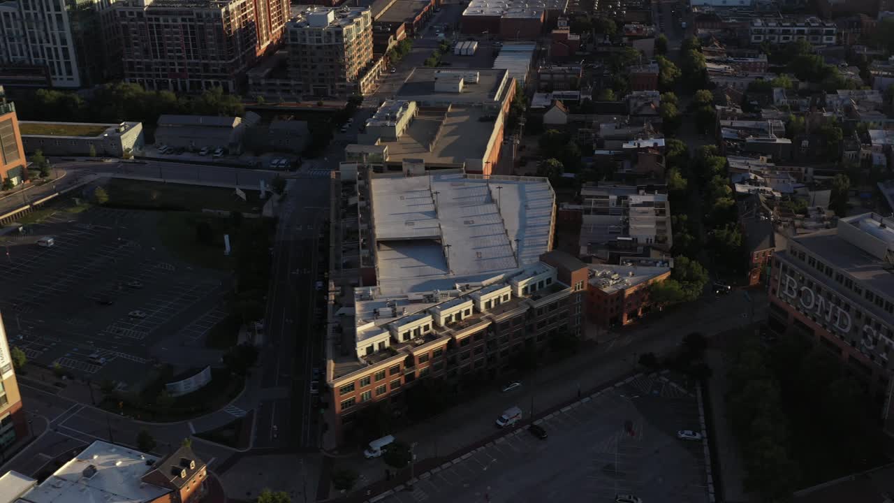 Aerial trucking tilt down towards Fells Point in Baltimore Maryland at golden hour sunrise