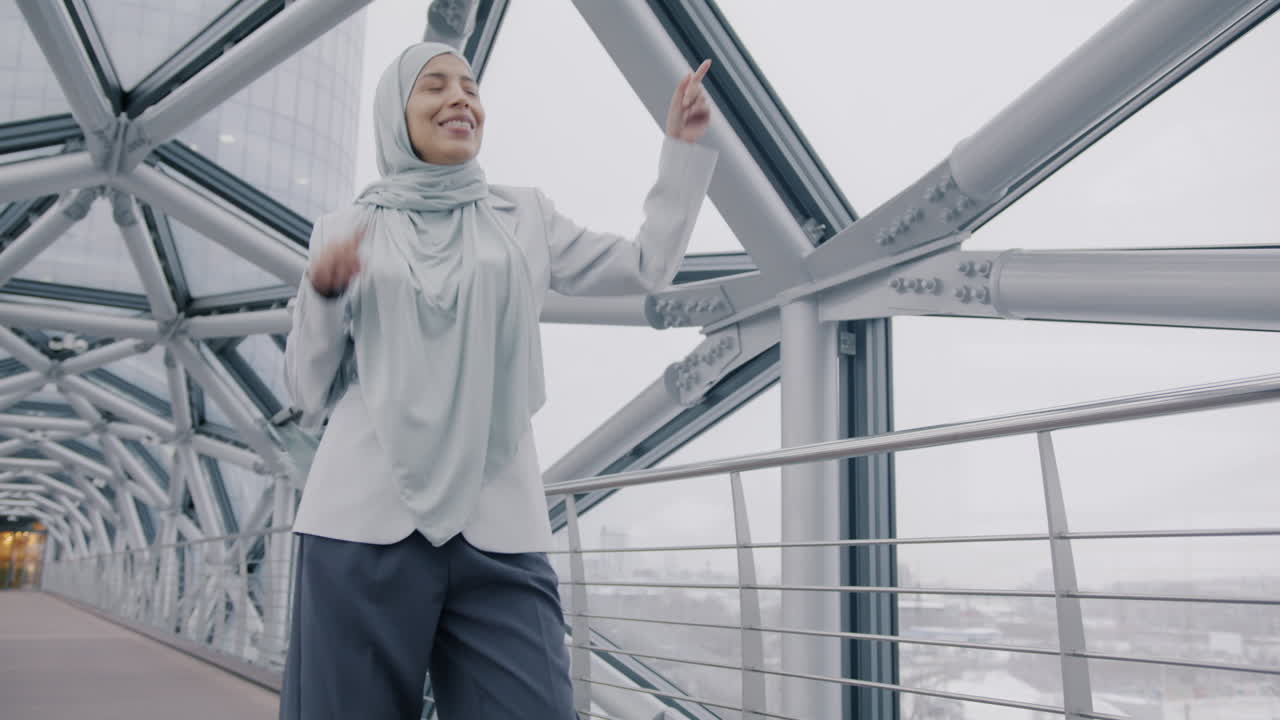Happy Businesswoman Dancing on a City Bridge