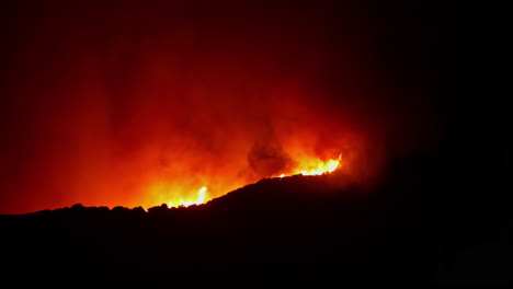 shot of smoke coming out of fire burning in malaga, spain on a dark night