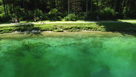 emerald lake with hikers and biker