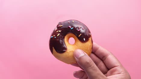 chocolate donut in hand