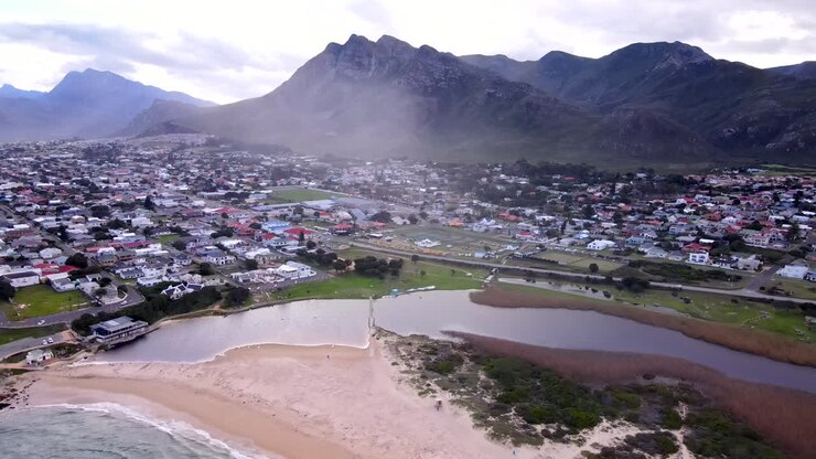 Aerial view of Kleinmond beach and lagoon with mountain in background