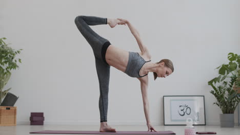 blond-haired female yogi having indoor yoga training