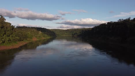 drone flying over iguazu river calm waters in amazon basin at border between brazil and argentina