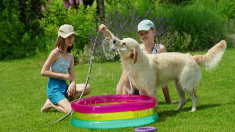 kids playing with dog in inflatable pool