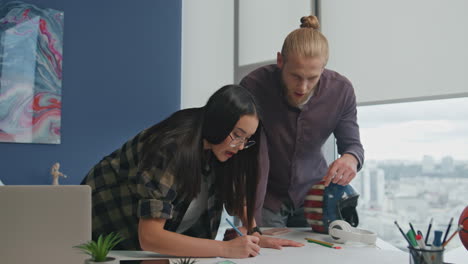 closeup people analyzing blueprint coworking place. confident man telling ideas