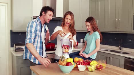 happy family making smoothie