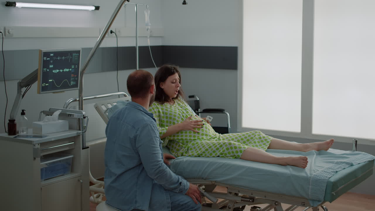 Caucasian pregnant woman getting labor contractions