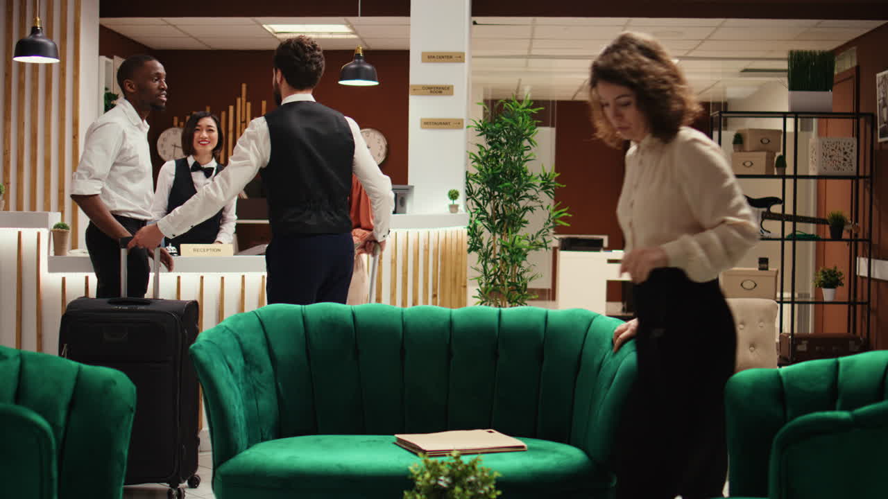 Bellboy showing tourists the way