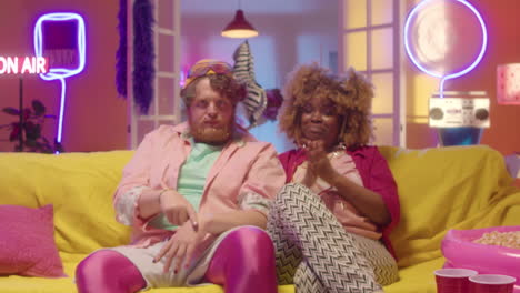 couple having fun and dancing on couch
