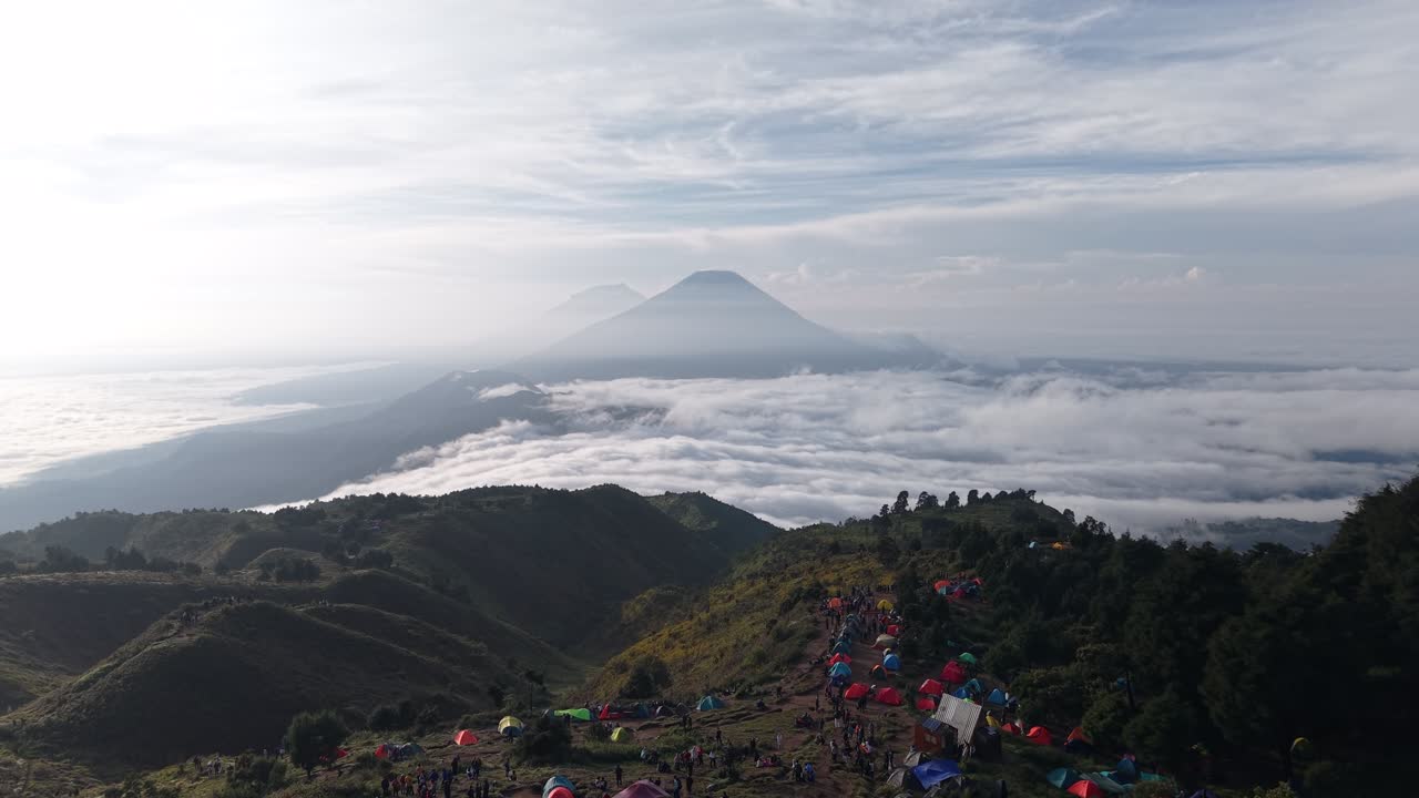 Aerial footage shows a group of climbers' tents and a beautiful morning view from the summit of Mount Prau. It is one of the most beautiful mountain peaks in Indonesia