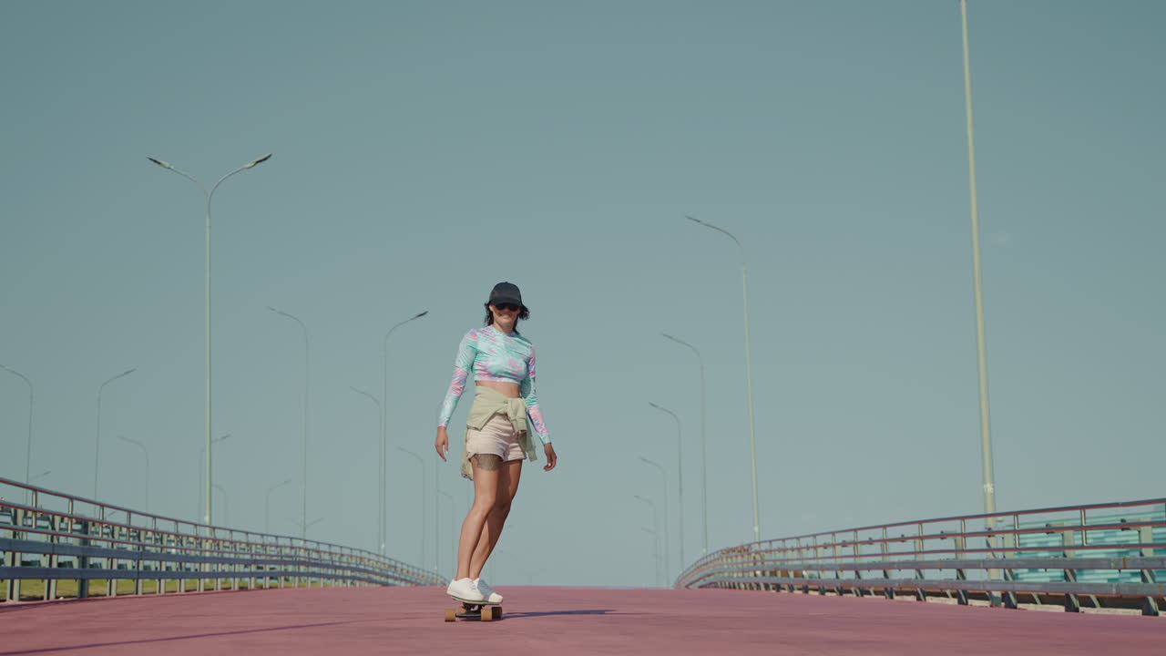 Woman Skateboarding on a Bridge