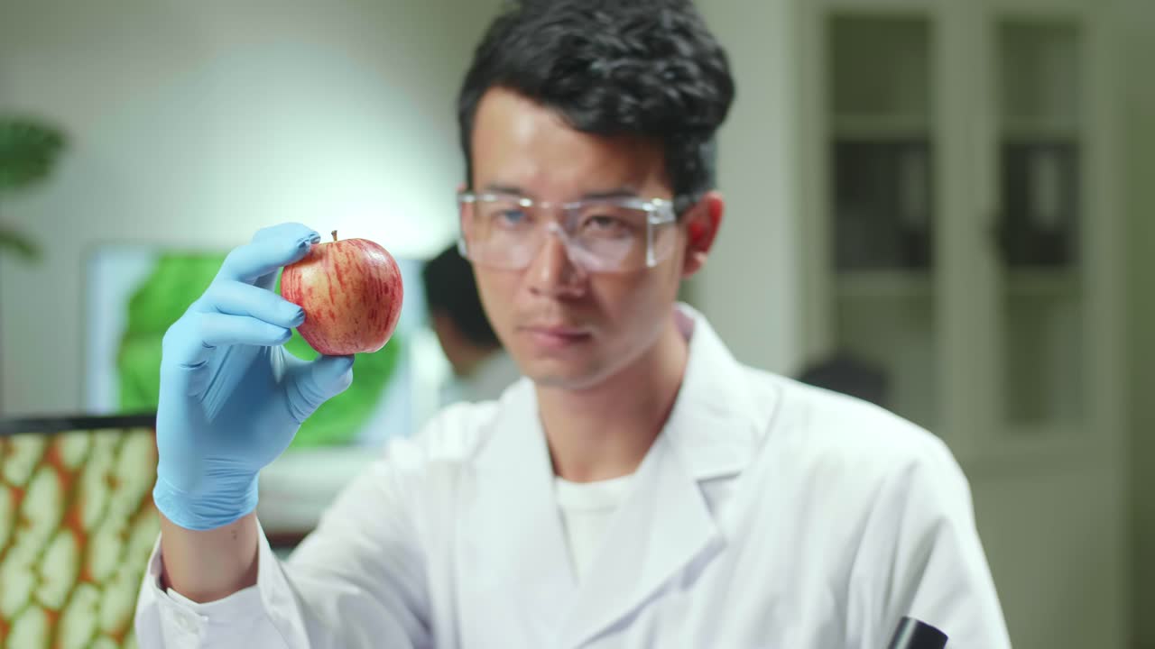 Close Up Botanist Man Looking At Apple,  Working In Agriculture Laboratory
